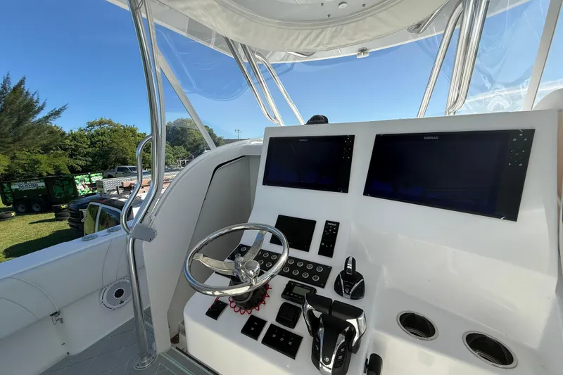 Slide: The Image of 2023 Contender 39 Fisharound boat helm with dual screens and controls. - 8