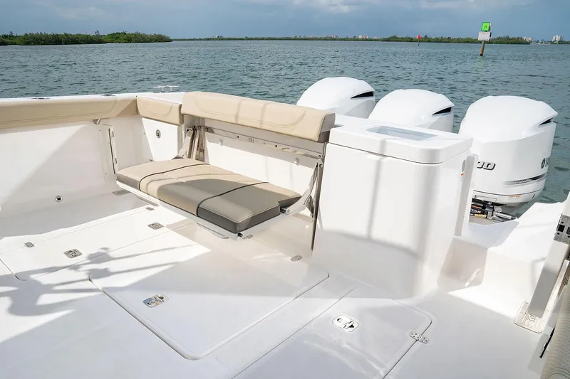 Slide: The Image of Manufacturer Provided Image: 2025 Pursuit OS 355 Offshore boat deck with seating and triple engines. - 12