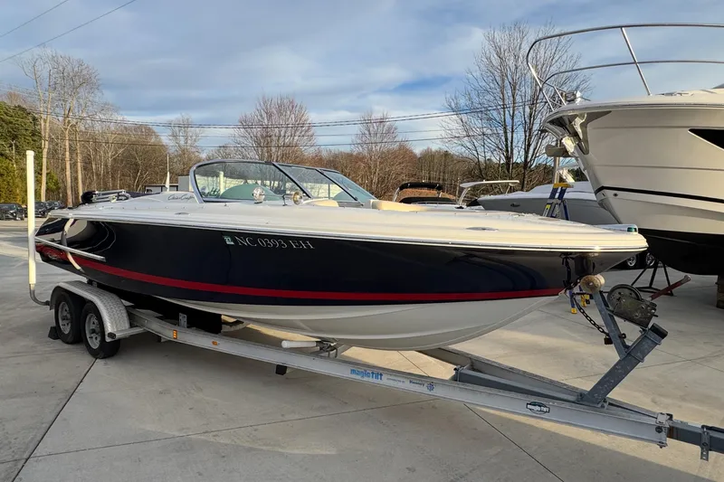 The Image of 2005 Chris-Craft Launch 22 boat on trailer, parked outdoors. - 0