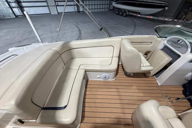 Slide: The Image of 2005 Chris-Craft Launch 22 boat interior with beige seating and wooden flooring. - 10