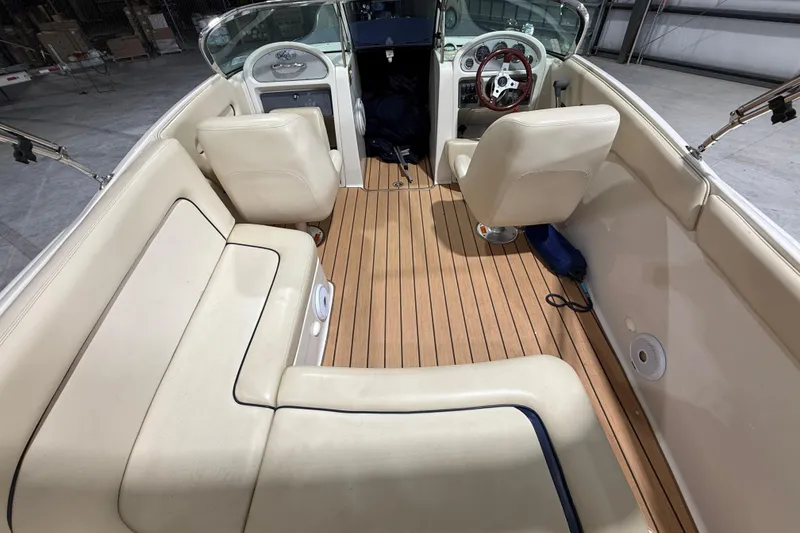 Slide: The Image of 2005 Chris-Craft Launch 22 interior with beige seating and wooden flooring. - 11