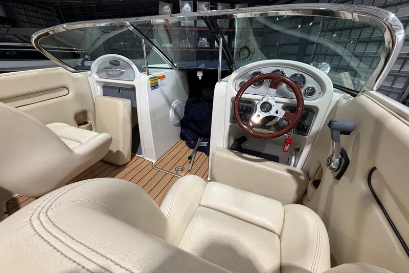 Slide: The Image of 2005 Chris-Craft Launch 22 boat interior with beige seating and wooden dashboard. - 12