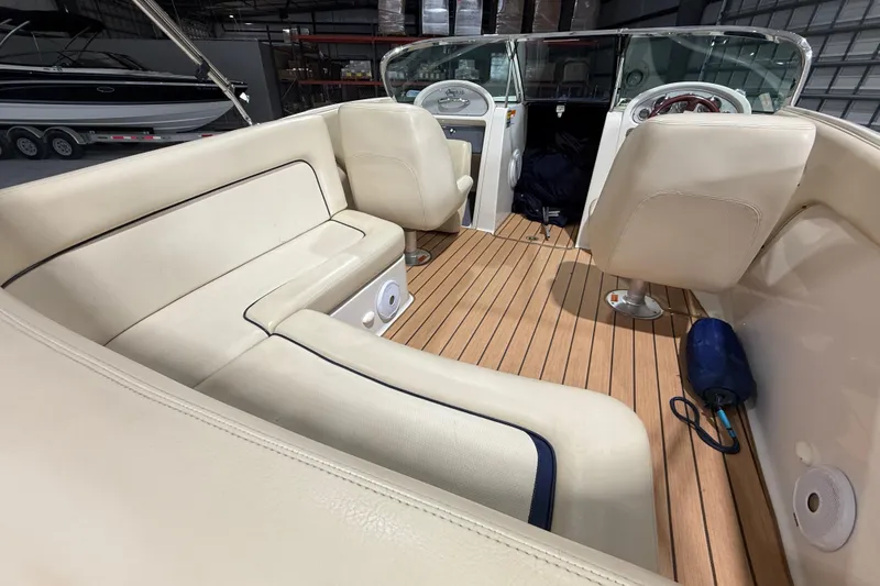 Slide: The Image of 2005 Chris-Craft Launch 22 boat interior with beige seating and wooden flooring. - 8