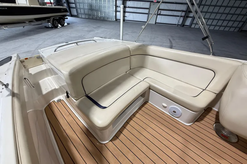 Slide: The Image of 2005 Chris-Craft Launch 22 boat interior with beige seating and teak flooring. - 9