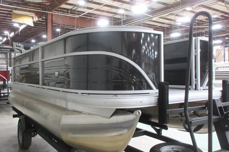 Slide: The Image of 2026 Sun Tracker Party Barge 18 DLX pontoon boat in a warehouse setting. - 10