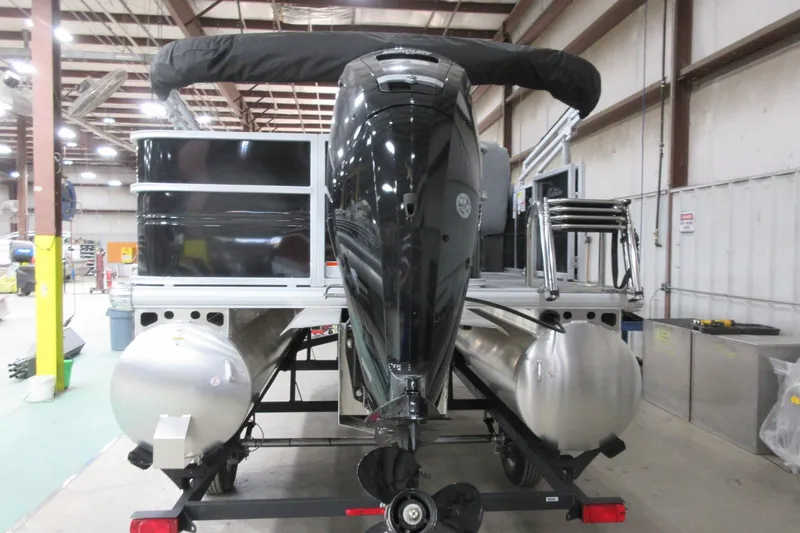 Slide: The Image of 2026 Sun Tracker Party Barge 18 DLX pontoon boat in a warehouse setting. - 4