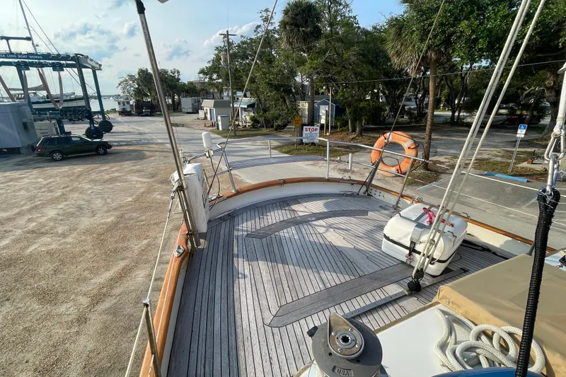 Slide: The Image of 1972 Rhodes 53 Motorsailor deck view at marina with lifebuoy and equipment. - 11