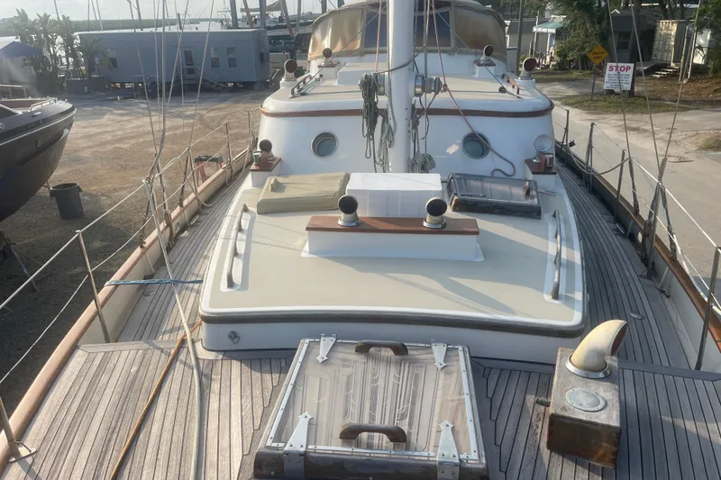 Slide: The Image of 1972 Rhodes 53 Motorsailor deck view with classic wooden details and nautical equipment. - 13