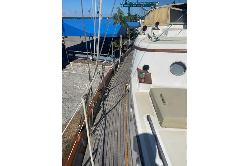 Slide: The Image of 1972 Rhodes 53 Motorsailor deck view with rigging and porthole. - 15