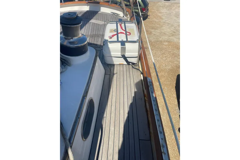 Slide: The Image of 1972 Rhodes 53 Motorsailor deck with winch and secured equipment. - 17
