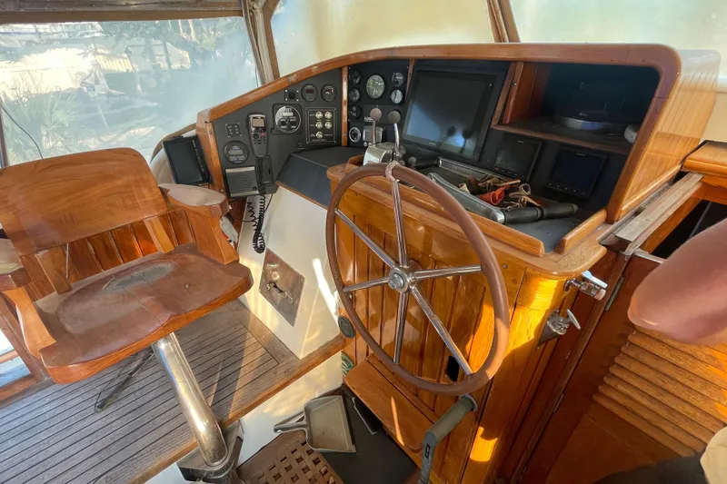 Slide: The Image of Interior helm of 1972 Rhodes 53 Motorsailor with wooden steering wheel and control panel. - 29
