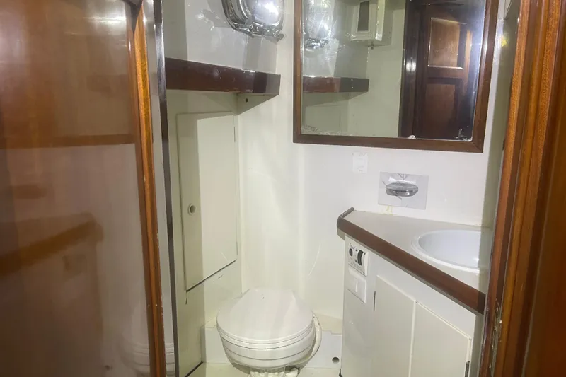 Slide: The Image of 1972 Rhodes 53 Motorsailor bathroom with wooden accents and compact design. - 35