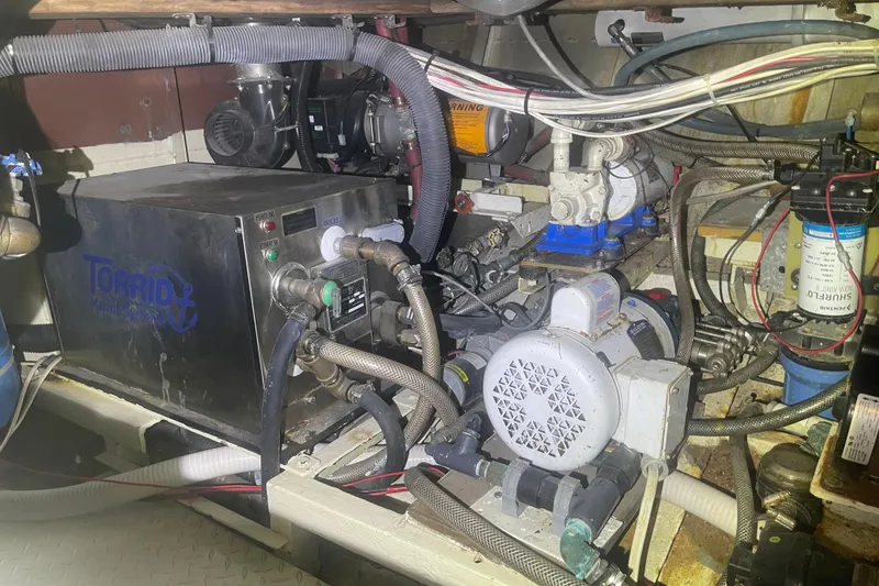 Slide: The Image of Engine room of a 1972 Rhodes 53 Motorsailor with various mechanical components. - 43