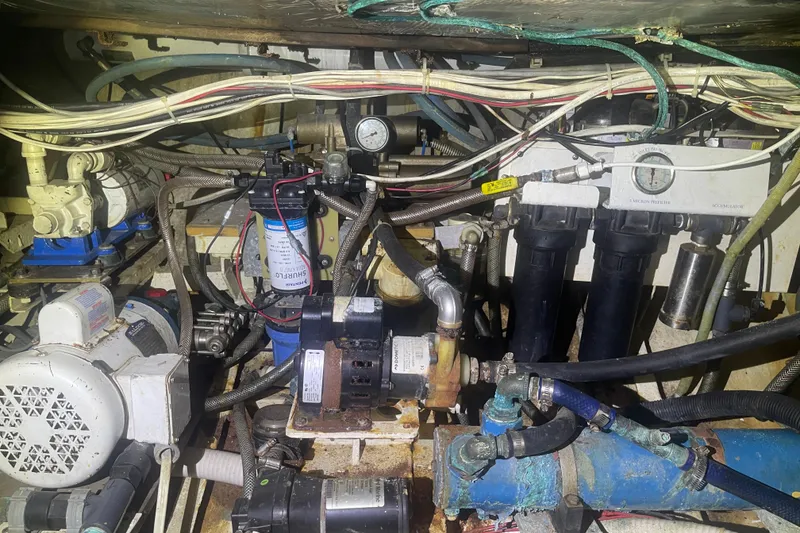 Slide: The Image of Engine room of 1972 Rhodes 53 Motorsailor with complex mechanical systems and wiring. - 44