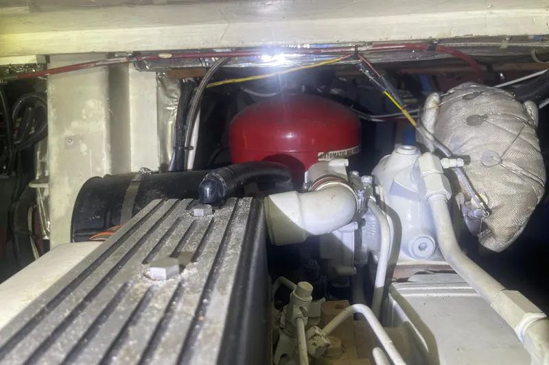 Slide: The Image of Engine compartment of a 1972 Rhodes 53 Motorsailor, showcasing mechanical components and wiring. - 45