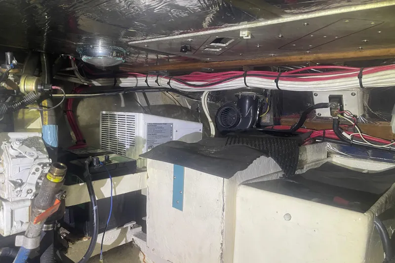 Slide: The Image of Engine room of 1972 Rhodes 53 Motorsailor with wiring and mechanical components. - 49