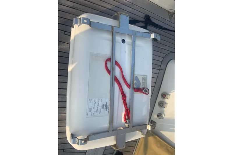 Slide: The Image of Liferaft on deck of 1972 Rhodes 53 Motorsailor with red rope and metal frame. - 51