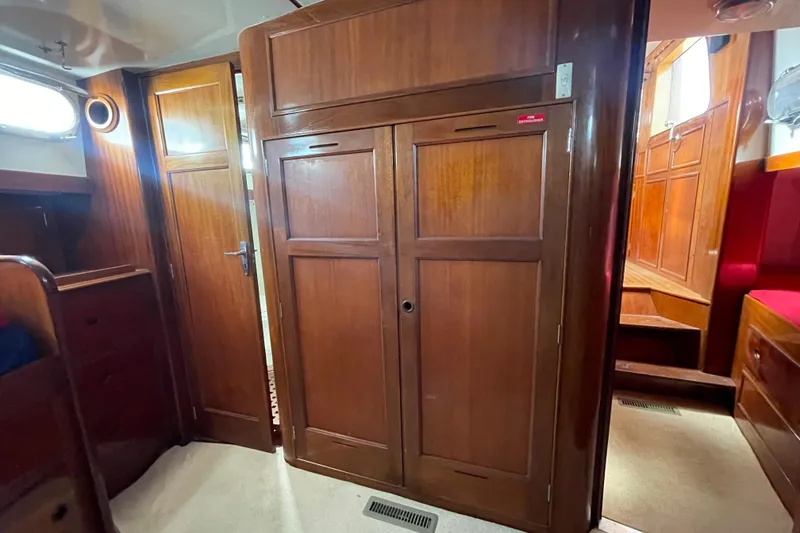Slide: The Image of Interior of 1972 Rhodes 53 Motorsailor with wooden cabinetry and cozy design. - 54
