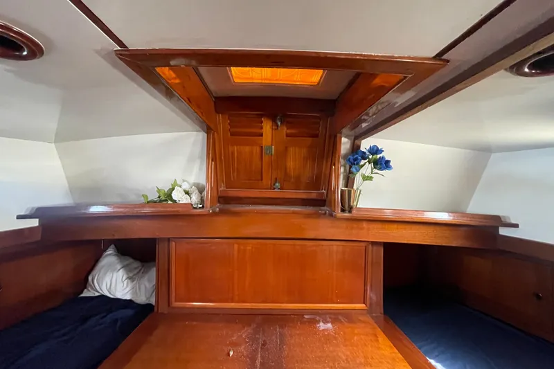 Slide: The Image of Interior of 1972 Rhodes 53 Motorsailor with wooden cabinetry and floral decor. - 55