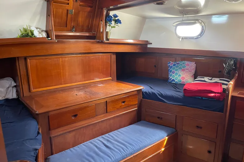 Slide: The Image of Cozy cabin interior of 1972 Rhodes 53 Motorsailor with wooden furnishings and nautical decor. - 56