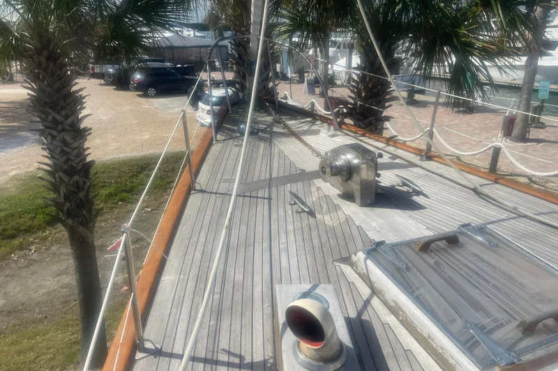 Slide: The Image of Deck of 1972 Rhodes 53 Motorsailor with palm trees and marina background. - 58