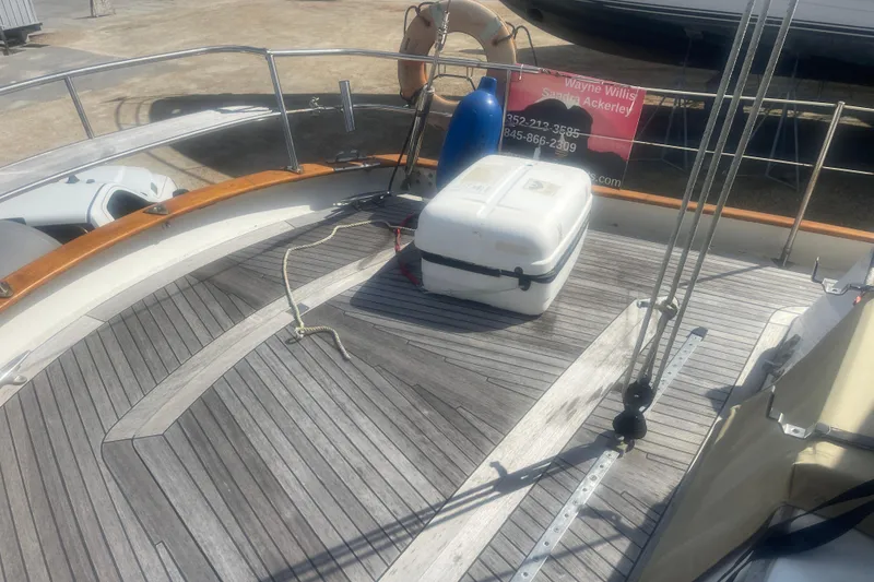 Slide: The Image of 1972 Rhodes 53 Motorsailor deck with wooden flooring and storage box. - 60