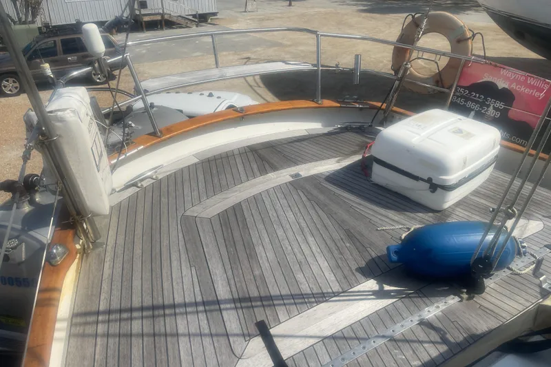 Slide: The Image of Deck of 1972 Rhodes 53 Motorsailor with wooden flooring and safety equipment. - 61