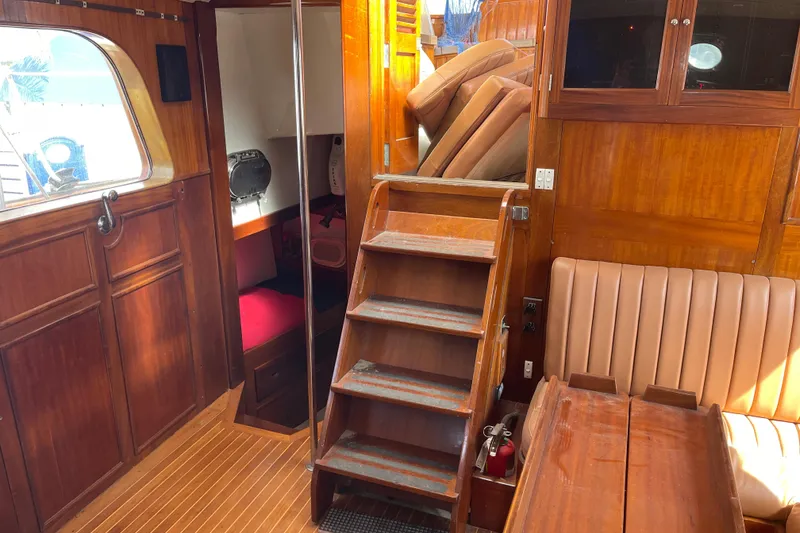 Slide: The Image of Interior of 1972 Rhodes 53 Motorsailor with wooden stairs and seating area. - 63