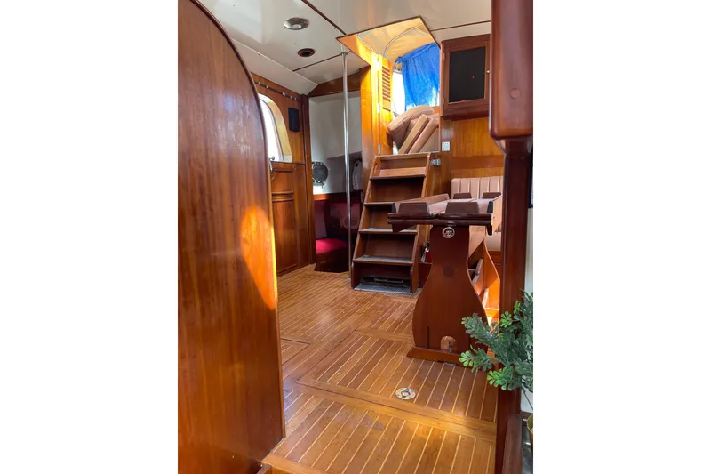 Slide: The Image of Interior of 1972 Rhodes 53 Motorsailor with wooden flooring and cozy seating area. - 66