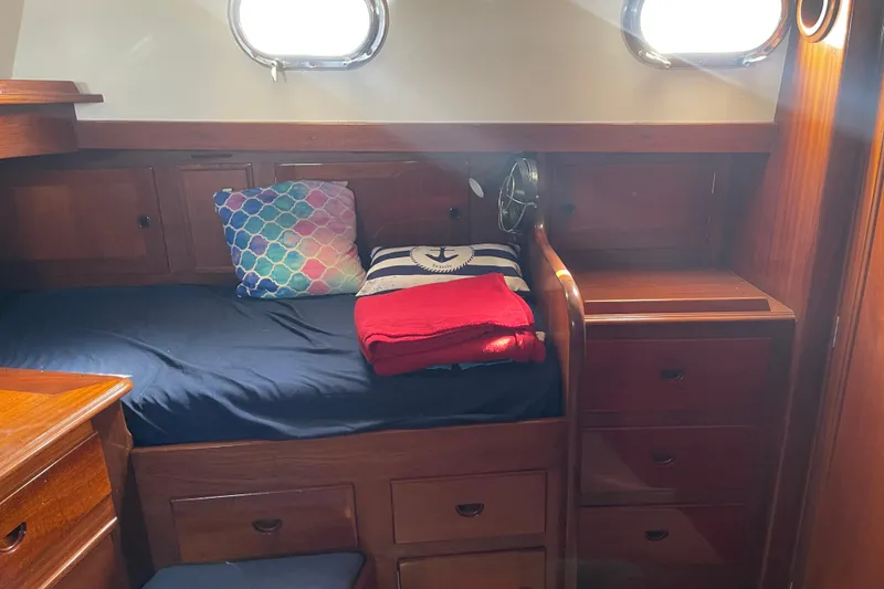 Slide: The Image of Cozy cabin interior of 1972 Rhodes 53 Motorsailor with wooden furnishings and nautical decor. - 72
