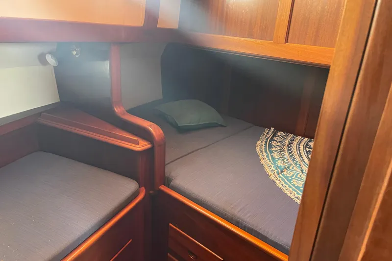 Slide: The Image of Cozy cabin interior of 1972 Rhodes 53 Motorsailor with wooden furnishings and bedding. - 76