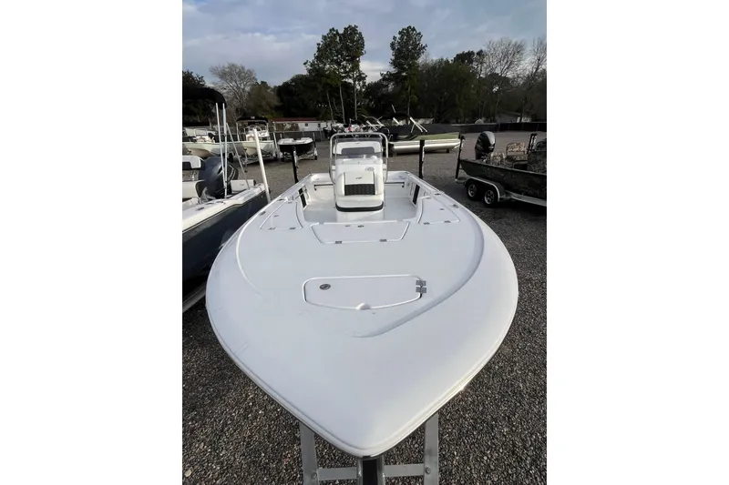 Slide: The Image of 2026 Tidewater 1910 Bay Max boat displayed outdoors on gravel lot. - 8