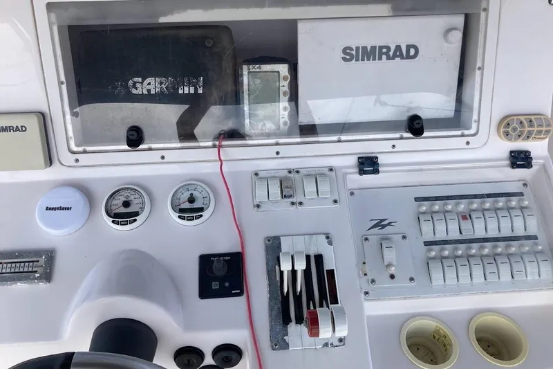 Slide: The Image of 2005 Donzi 35 ZF Daytona dashboard with Garmin and Simrad navigation systems. - 28