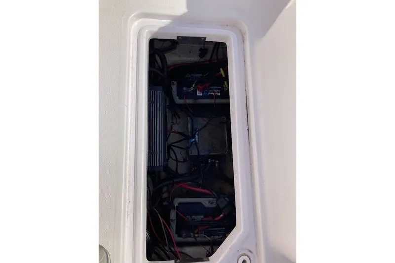 Slide: The Image of 2005 Donzi 35 ZF Daytona boat battery compartment with wiring and components. - 36