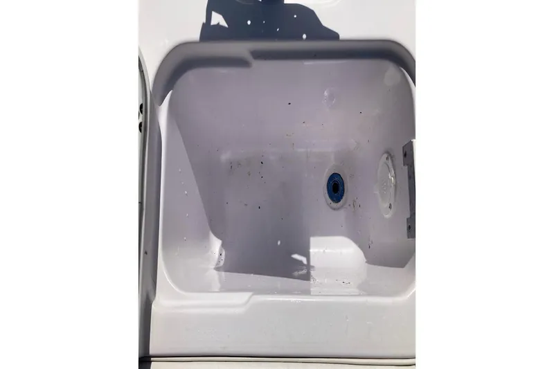 Slide: The Image of 2005 Donzi 35 ZF Daytona boat compartment with drain plug and slight debris. - 40