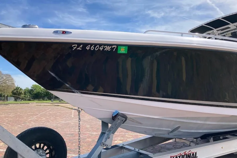 Slide: The Image of 2005 Donzi 35 ZF Daytona boat on trailer, parked outdoors under blue sky. - 8