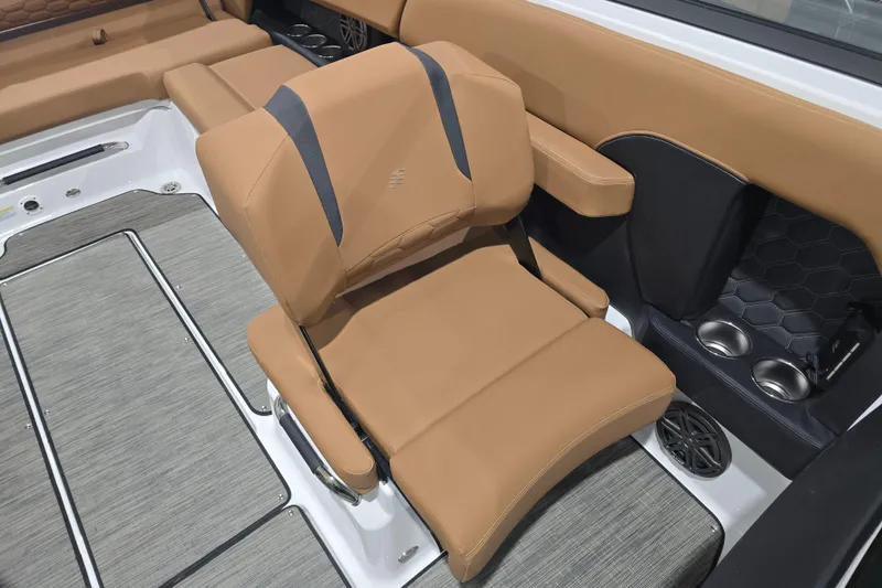 Slide: The Image of 2026 Four Winns H6 boat interior with tan seating and cup holders. - 15