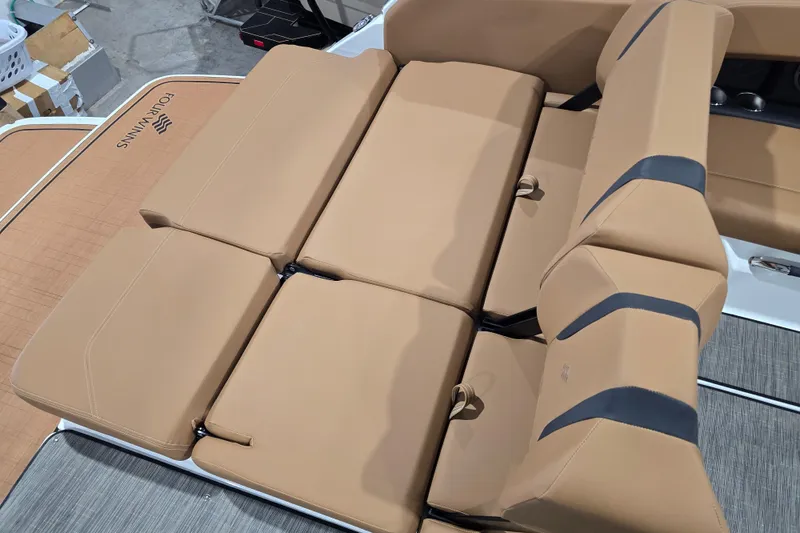Slide: The Image of 2026 Four Winns H6 boat with tan cushioned seating and sleek design. - 18