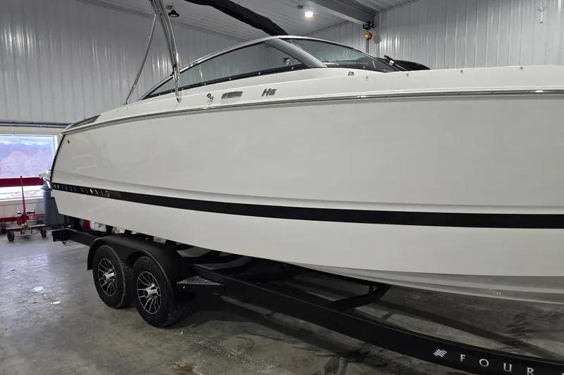 Slide: The Image of 2026 Four Winns H6 boat on trailer in indoor storage facility. - 3