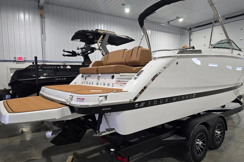 Slide: The Image of 2026 Four Winns H6 boat in showroom, featuring sleek design and modern amenities. - 4