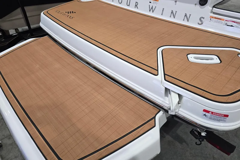 Slide: The Image of 2026 Four Winns H6 boat deck with teak-style flooring and safety warnings. - 5