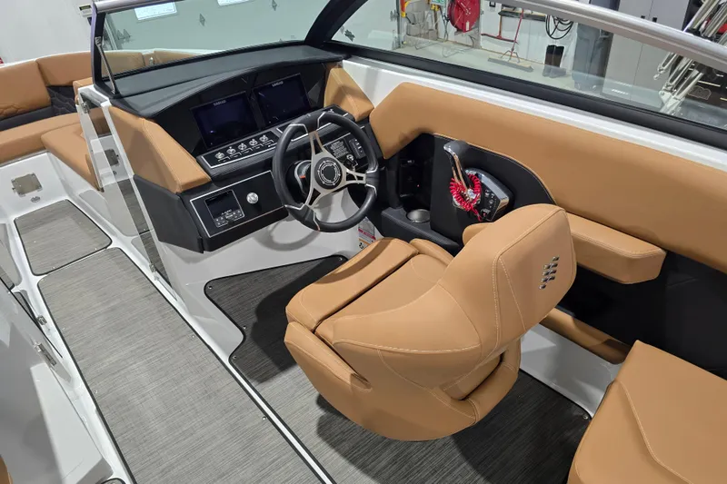 Slide: The Image of 2026 Four Winns H6 boat interior with tan leather seating and modern dashboard. - 9