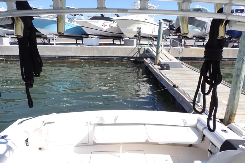 Slide: The Image of 2006 Wellcraft 330 Coastal boat docked at marina with other vessels in background. - 10
