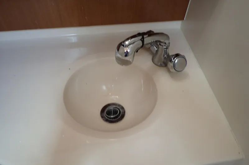 Slide: The Image of Chrome faucet and sink in 2006 Wellcraft 330 Coastal boat bathroom. - 109