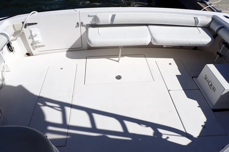 Slide: The Image of 2006 Wellcraft 330 Coastal boat deck with white seating and storage compartments. - 11