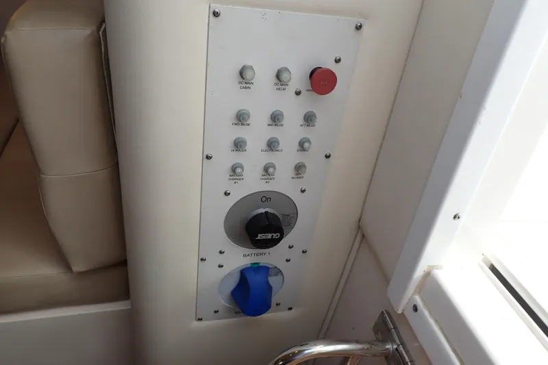 Slide: The Image of Control panel of a 2006 Wellcraft 330 Coastal boat, featuring various switches and dials. - 112