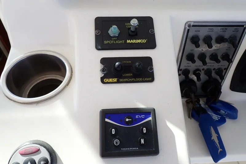 Slide: The Image of Control panel of a 2006 Wellcraft 330 Coastal boat with spotlight and floodlight switches. - 114
