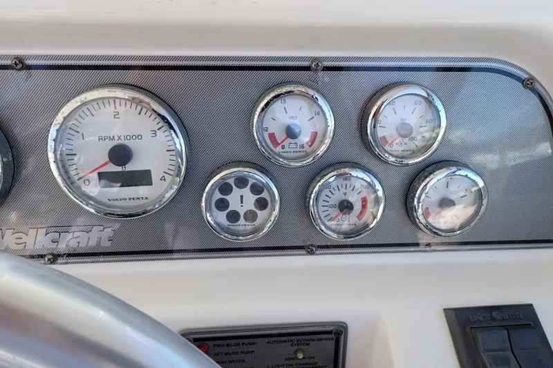 Slide: The Image of Dashboard of a 2006 Wellcraft 330 Coastal boat with various gauges and controls. - 116