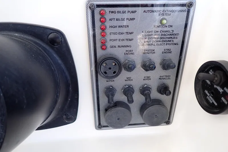 Slide: The Image of Control panel of a 2006 Wellcraft 330 Coastal boat with various switches and indicators. - 117