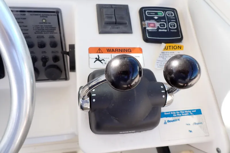 Slide: The Image of Control panel of a 2006 Wellcraft 330 Coastal boat with throttle levers. - 120